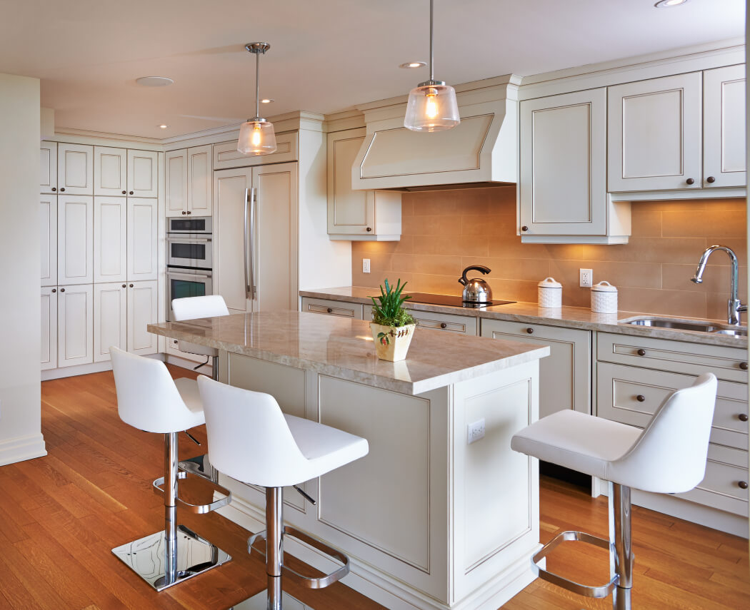 Renovated kitchen with white cabinets and an island.